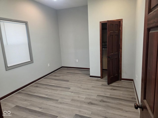 624 Warren Ave, Indianapolis, IN 46221 - unfurnished room with light wood-style floors and baseboards