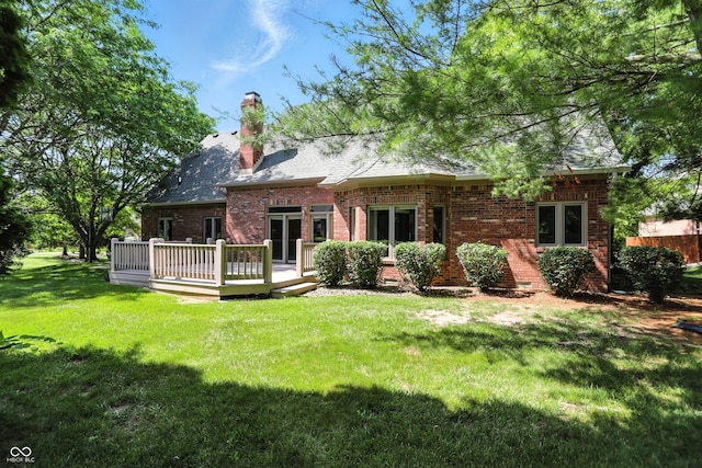 6183 Whitetail Run, Greenwood, IN 46143 - back of house with brick siding, a deck, a lawn, and a chimney