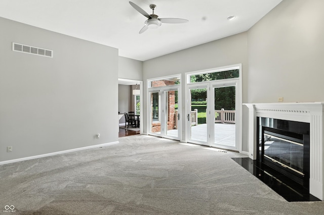 6183 Whitetail Run, Greenwood, IN 46143 - unfurnished living room featuring carpet floors, ceiling fan, and a fireplace with flush hearth