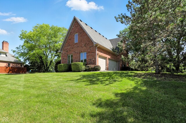 6183 Whitetail Run, Greenwood, IN 46143 - view of home's exterior with brick siding, a garage, a yard, and a shingled roof