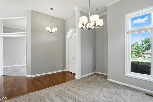 6183 Whitetail Run, Greenwood, IN 46143 - unfurnished dining area with a chandelier, carpet flooring, and crown molding