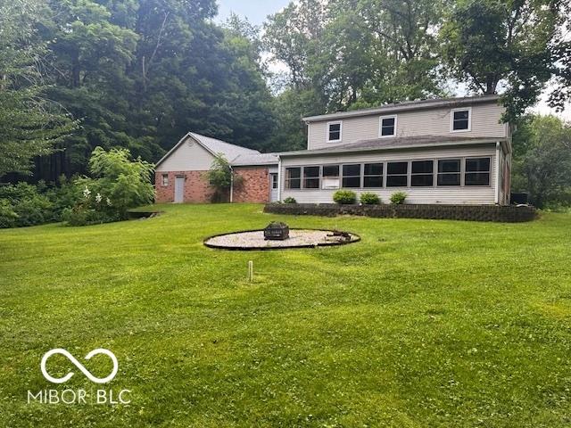 3815 Briar Rdg, Monrovia, IN 46157 - rear view of property featuring an outdoor fire pit and a yard