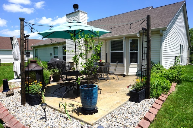 6422 Hollingsworth Dr, Indianapolis, IN 46268 - rear view of house with a patio, roof with shingles, and a chimney