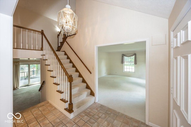 8315 Union Chapel Rd, Indianapolis, IN 46240 - staircase with carpet floors, a chandelier, and high vaulted ceiling