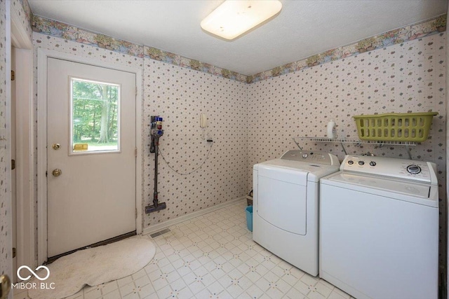 8315 Union Chapel Rd, Indianapolis, IN 46240 - laundry room featuring washing machine and clothes dryer, wallpapered walls, and light floors