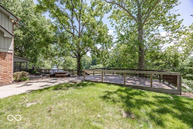 8315 Union Chapel Rd, Indianapolis, IN 46240 - view of green lawn with a deck, view of wooded area, and a patio