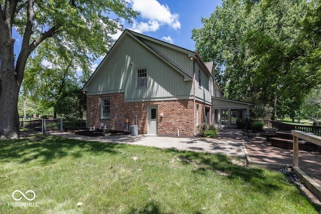 8315 Union Chapel Rd, Indianapolis, IN 46240 - view of side of home with brick siding, a deck, and a patio