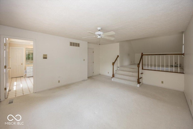 8315 Union Chapel Rd, Indianapolis, IN 46240 - empty room featuring a ceiling fan, stairs, light carpet, and a textured ceiling