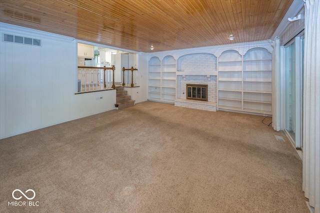 8315 Union Chapel Rd, Indianapolis, IN 46240 - unfurnished living room featuring carpet floors, a brick fireplace, wood ceiling, and built in shelves