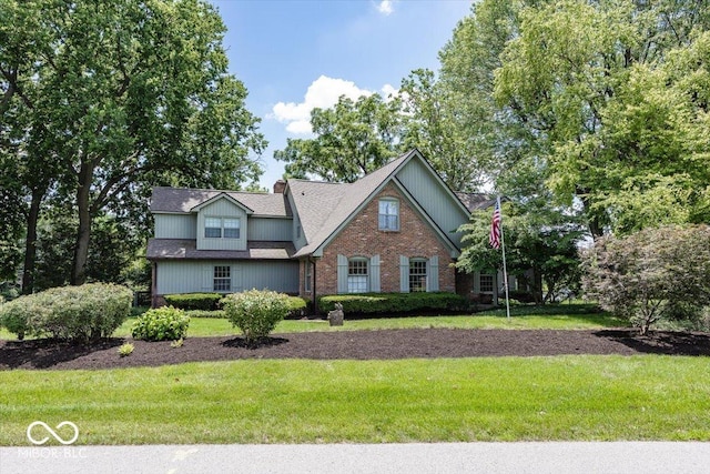 8315 Union Chapel Rd, Indianapolis, IN 46240 - view of front facade with a front yard, a chimney, and brick siding