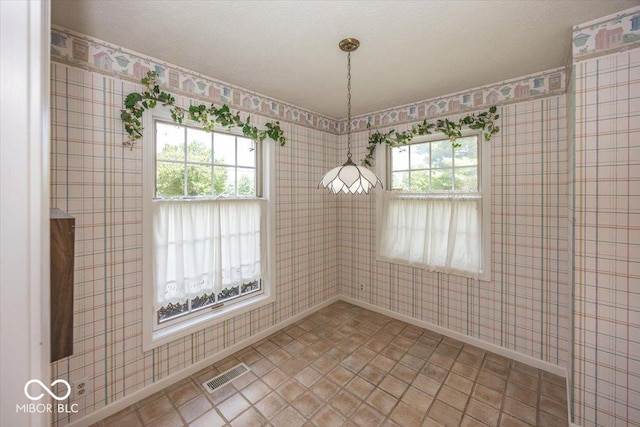 8315 Union Chapel Rd, Indianapolis, IN 46240 - unfurnished dining area featuring wallpapered walls and a textured ceiling