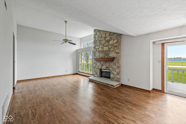 4609 Framington Ct, Indianapolis, IN 46254 - unfurnished living room featuring a textured ceiling, ceiling fan, healthy amount of natural light, wood finished floors, and vaulted ceiling