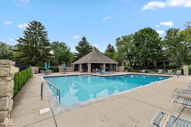 4609 Framington Ct, Indianapolis, IN 46254 - community pool featuring a patio area, a gazebo, and view of wooded area