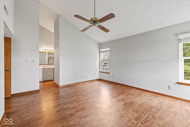 4609 Framington Ct, Indianapolis, IN 46254 - spare room with wood finished floors, a ceiling fan, a textured ceiling, and high vaulted ceiling