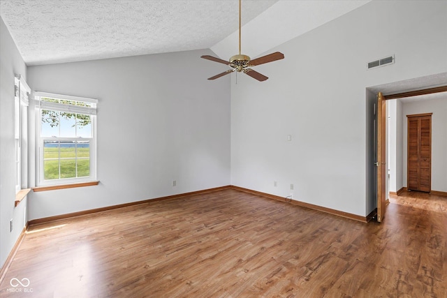 4609 Framington Ct, Indianapolis, IN 46254 - empty room with wood finished floors, ceiling fan, a textured ceiling, and high vaulted ceiling
