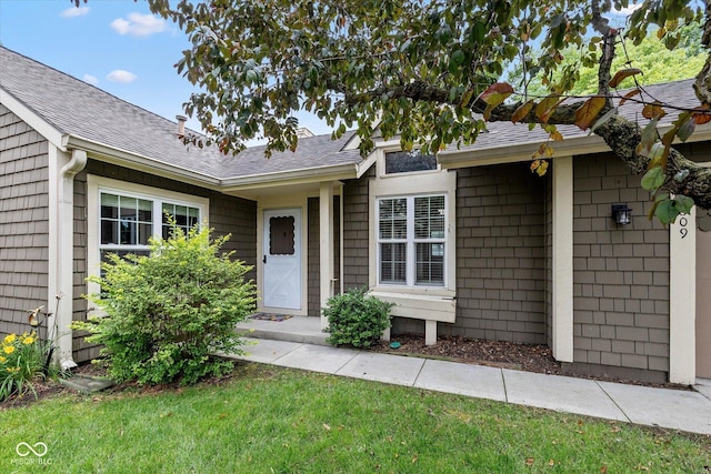 4609 Framington Ct, Indianapolis, IN 46254 - view of exterior entry featuring roof with shingles and a lawn