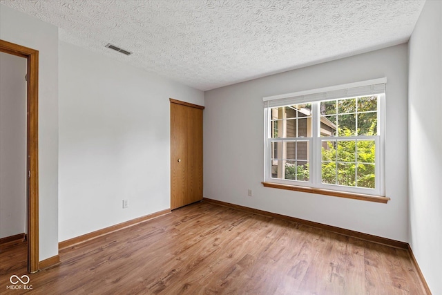 4609 Framington Ct, Indianapolis, IN 46254 - empty room featuring wood finished floors and a textured ceiling