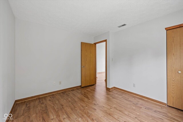 4609 Framington Ct, Indianapolis, IN 46254 - spare room featuring light wood finished floors and a textured ceiling