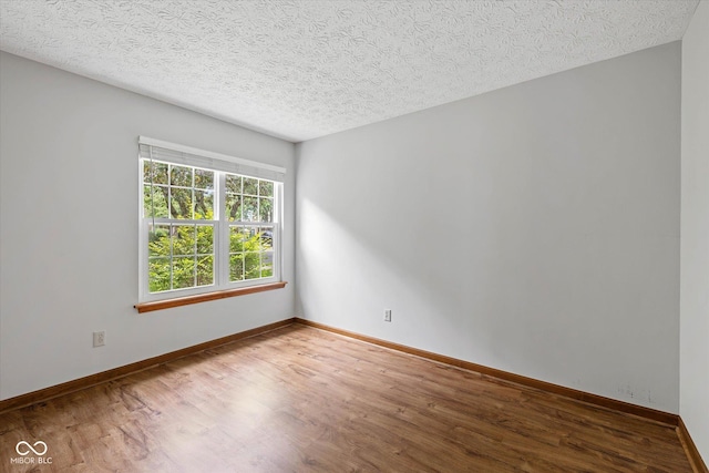 4609 Framington Ct, Indianapolis, IN 46254 - spare room with wood finished floors and a textured ceiling