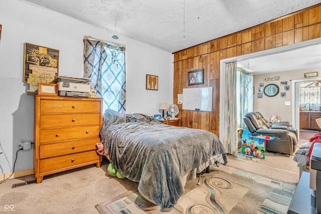 850 Duane St, Franklin, IN 46131 - bedroom with wood walls, light colored carpet, and a textured ceiling