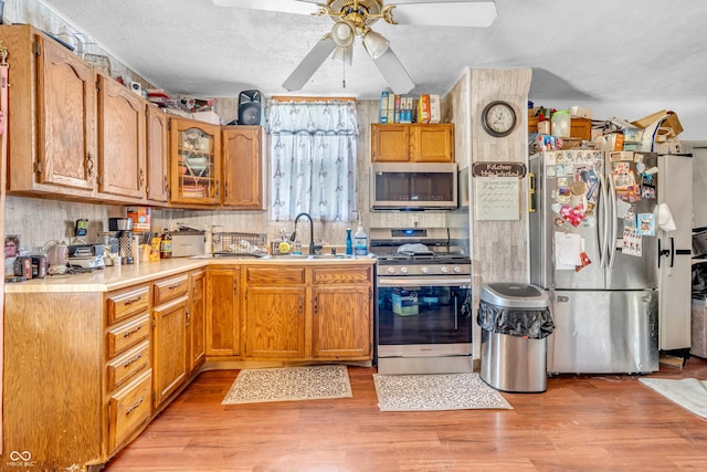 850 Duane St, Franklin, IN 46131 - kitchen featuring appliances with stainless steel finishes, a ceiling fan, light countertops, light wood-style flooring, and a textured ceiling