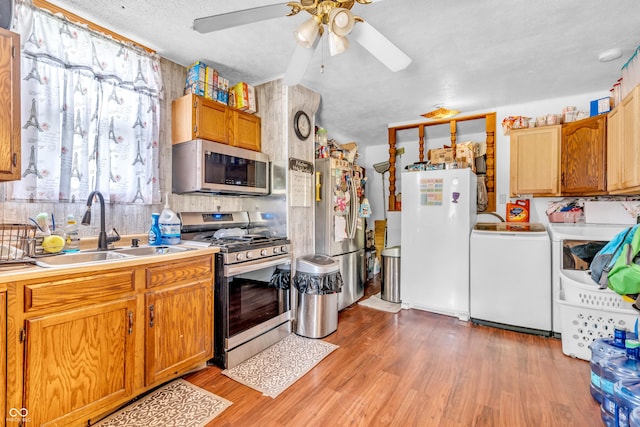 850 Duane St, Franklin, IN 46131 - kitchen featuring appliances with stainless steel finishes, washer / dryer, ceiling fan, light wood-type flooring, and light countertops