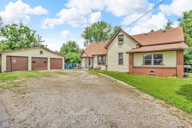 850 Duane St, Franklin, IN 46131 - view of front of property featuring a detached garage, an outdoor structure, roof with shingles, a front yard, and brick siding