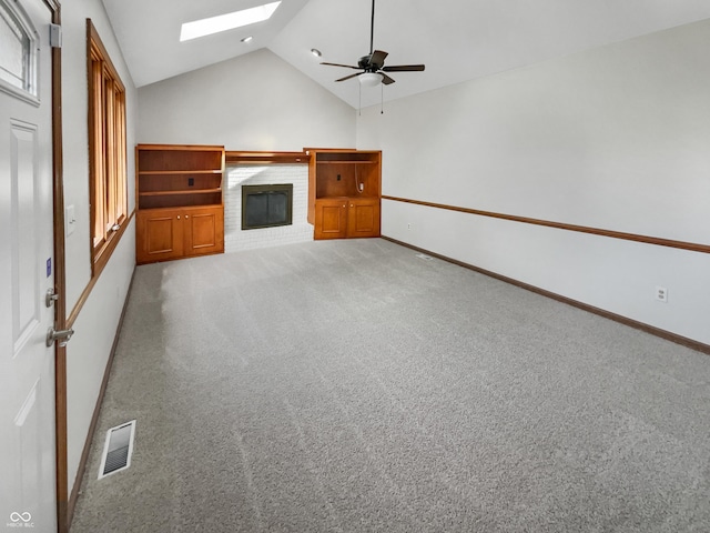 757 Winter Way, Carmel, IN 46032 - unfurnished living room with a skylight, a ceiling fan, carpet floors, a fireplace, and high vaulted ceiling