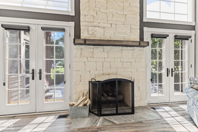 4465 W Woodbridge Ln, New Palestine, IN 46163 - detailed view of french doors, a fireplace, and wood finished floors