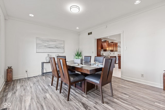 4465 W Woodbridge Ln, New Palestine, IN 46163 - dining area featuring light wood-style flooring, ornamental molding, and recessed lighting