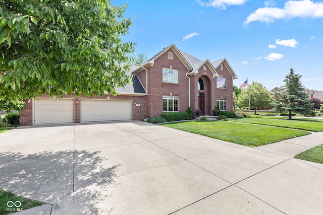 4465 W Woodbridge Ln, New Palestine, IN 46163 - view of front facade with brick siding, a front lawn, concrete driveway, and a garage