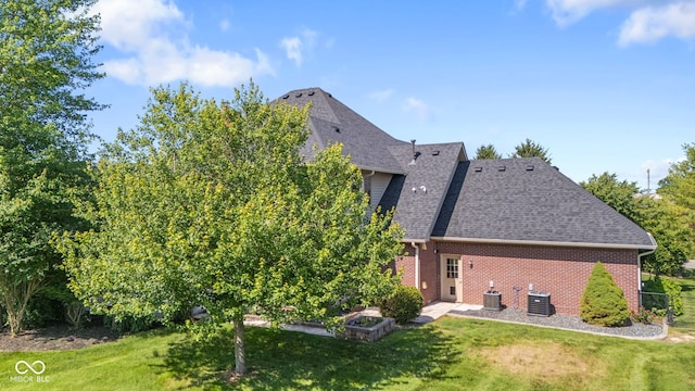 4465 W Woodbridge Ln, New Palestine, IN 46163 - rear view of house with a yard, a shingled roof, and brick siding