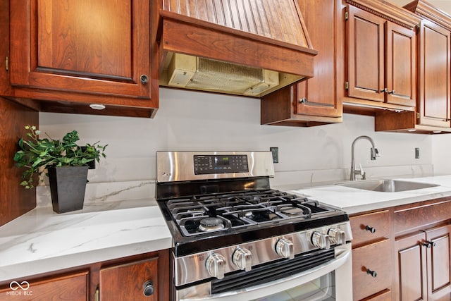 4465 W Woodbridge Ln, New Palestine, IN 46163 - kitchen with gas stove, range hood, light stone counters, and brown cabinetry