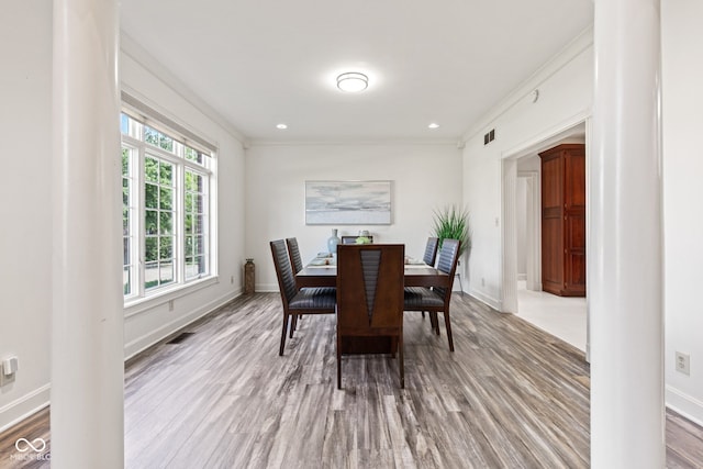 4465 W Woodbridge Ln, New Palestine, IN 46163 - dining area with wood finished floors, ornamental molding, and recessed lighting
