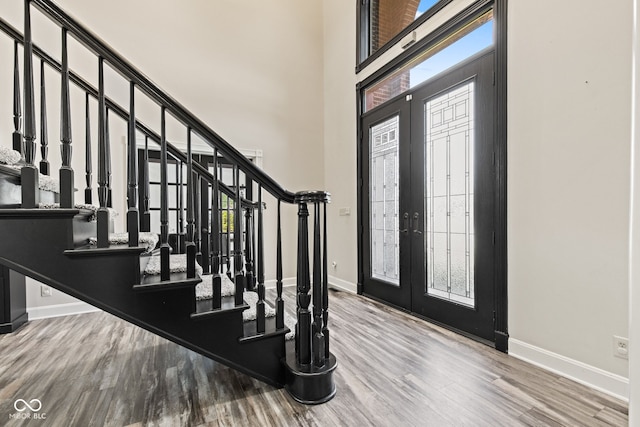 4465 W Woodbridge Ln, New Palestine, IN 46163 - foyer entrance featuring wood finished floors, plenty of natural light, stairs, and a high ceiling