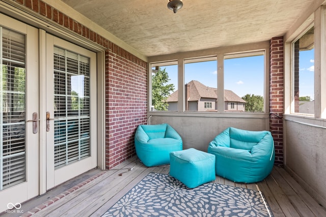 4465 W Woodbridge Ln, New Palestine, IN 46163 - sunroom with wood-type flooring, plenty of natural light, brick wall, and french doors