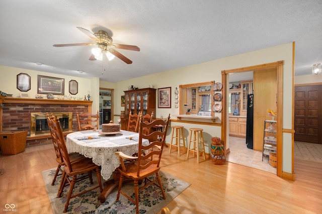 5081 N 500 W, Fairland, IN 46126 - dining area with light wood finished floors, ceiling fan, and a brick fireplace