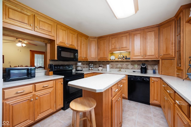 5081 N 500 W, Fairland, IN 46126 - kitchen featuring black appliances, light countertops, a kitchen island, and tasteful backsplash