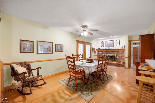 5081 N 500 W, Fairland, IN 46126 - dining space featuring ceiling fan, light wood-type flooring, a fireplace, and a textured ceiling