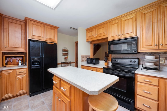 5081 N 500 W, Fairland, IN 46126 - kitchen featuring black appliances, light countertops, decorative backsplash, a kitchen island, and light tile patterned floors