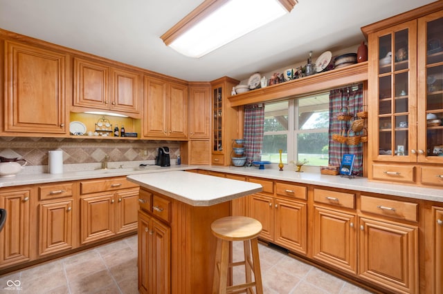 5081 N 500 W, Fairland, IN 46126 - kitchen featuring brown cabinets, a kitchen island, light countertops, tasteful backsplash, and a kitchen bar