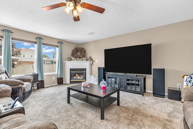 7047 Lancaster Ln, Avon, IN 46123 - living area with ceiling fan, carpet, a textured ceiling, and a glass covered fireplace