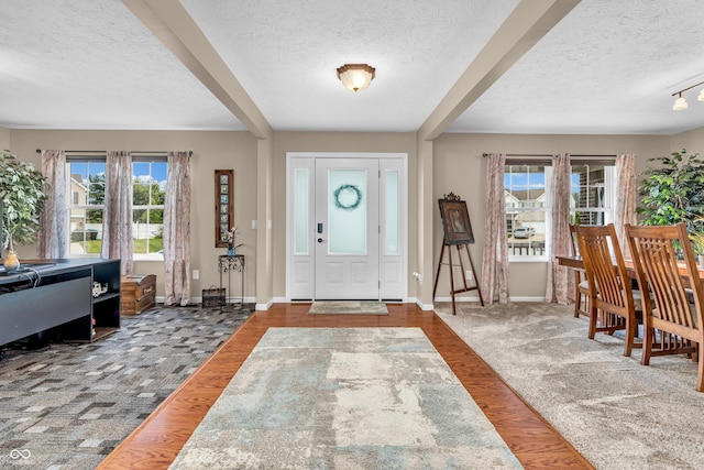 7047 Lancaster Ln, Avon, IN 46123 - entrance foyer featuring a textured ceiling, beamed ceiling, carpet flooring, and wood finished floors