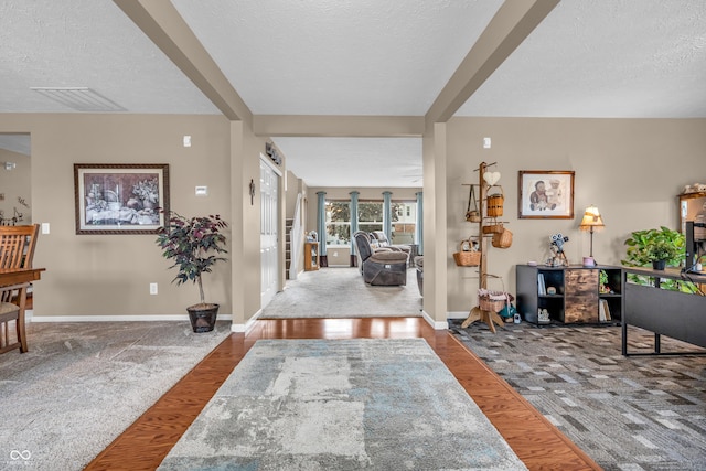 7047 Lancaster Ln, Avon, IN 46123 - foyer with a textured ceiling, carpet floors, and wood finished floors