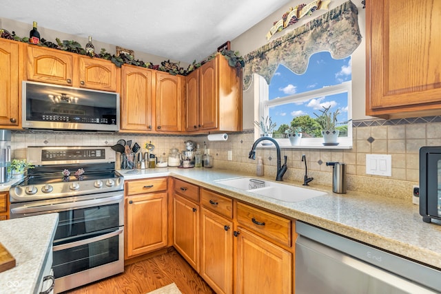 7047 Lancaster Ln, Avon, IN 46123 - kitchen with stainless steel appliances, light countertops, decorative backsplash, and light wood-type flooring