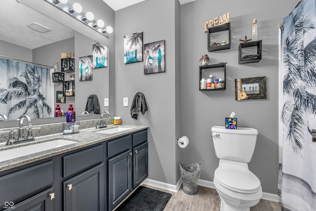 7047 Lancaster Ln, Avon, IN 46123 - bathroom featuring double vanity, wood finished floors, and a shower with shower curtain