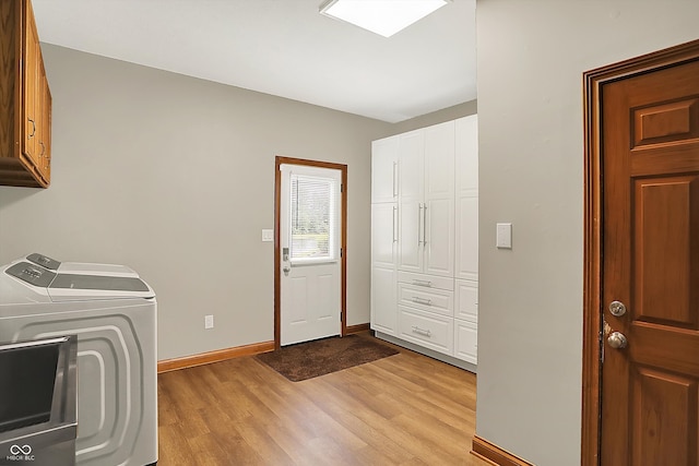 369 Rodeo Dr, Indianapolis, IN 46217 - washroom with cabinet space, washing machine and dryer, and light wood finished floors