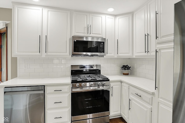 369 Rodeo Dr, Indianapolis, IN 46217 - kitchen featuring stainless steel appliances, white cabinets, light countertops, and recessed lighting