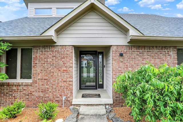 369 Rodeo Dr, Indianapolis, IN 46217 - property entrance featuring roof with shingles and brick siding