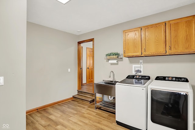 369 Rodeo Dr, Indianapolis, IN 46217 - washroom featuring cabinet space, light wood-style floors, and washer and dryer